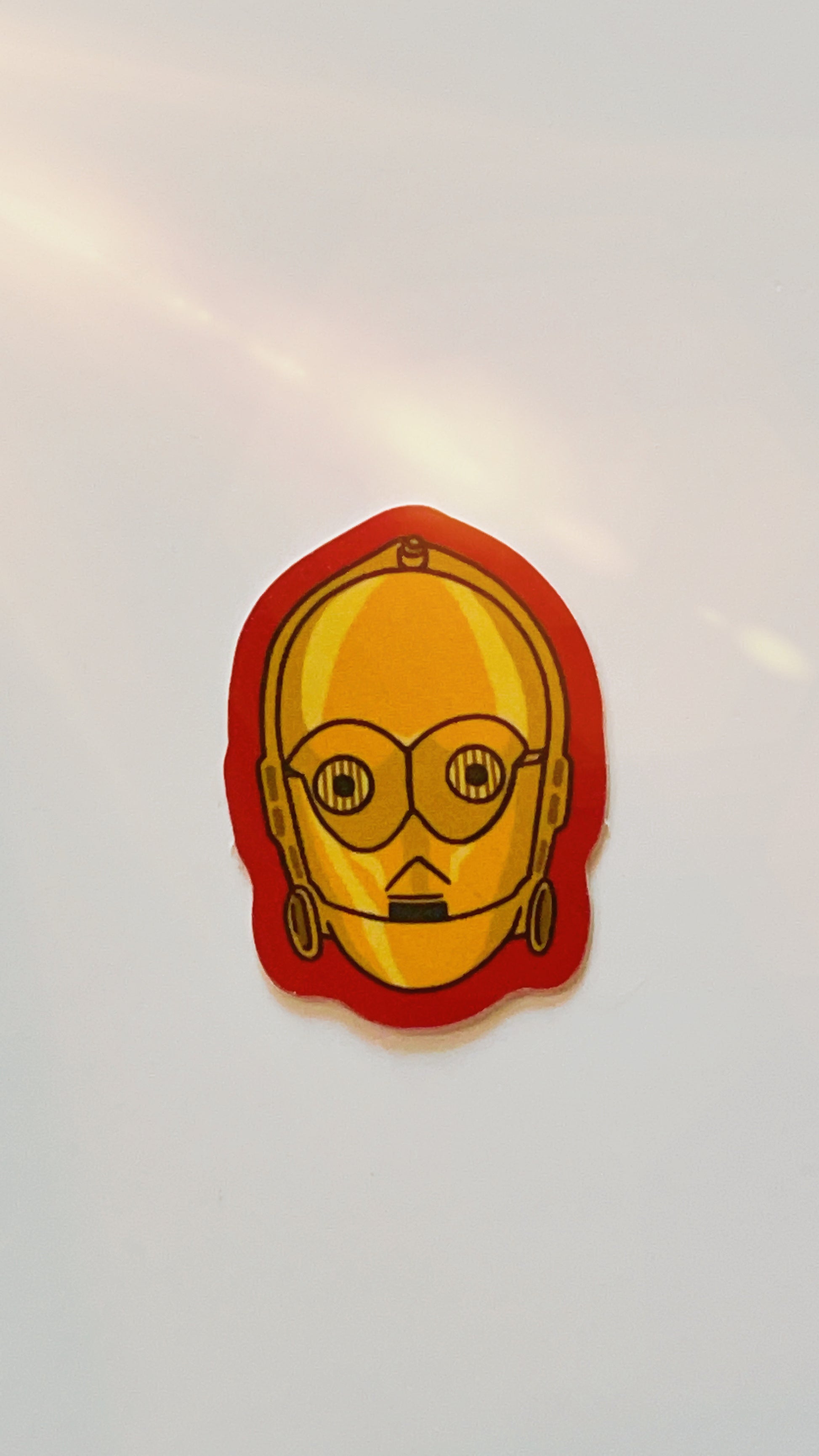 Vinyl sticker of star wars droid c3p0 with red edges.