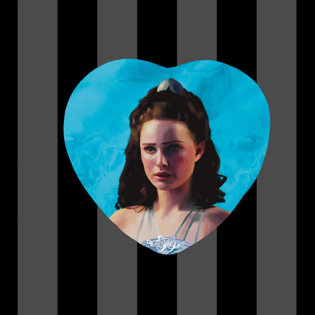 Item is a heart shaped button of Padme Amidala during Revenge of the Sith with a bright blue background.