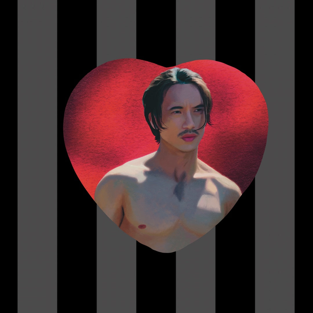 Item is a heart shaped button of Manny Jacinto as Qimir from The acolyte with a bright red background.