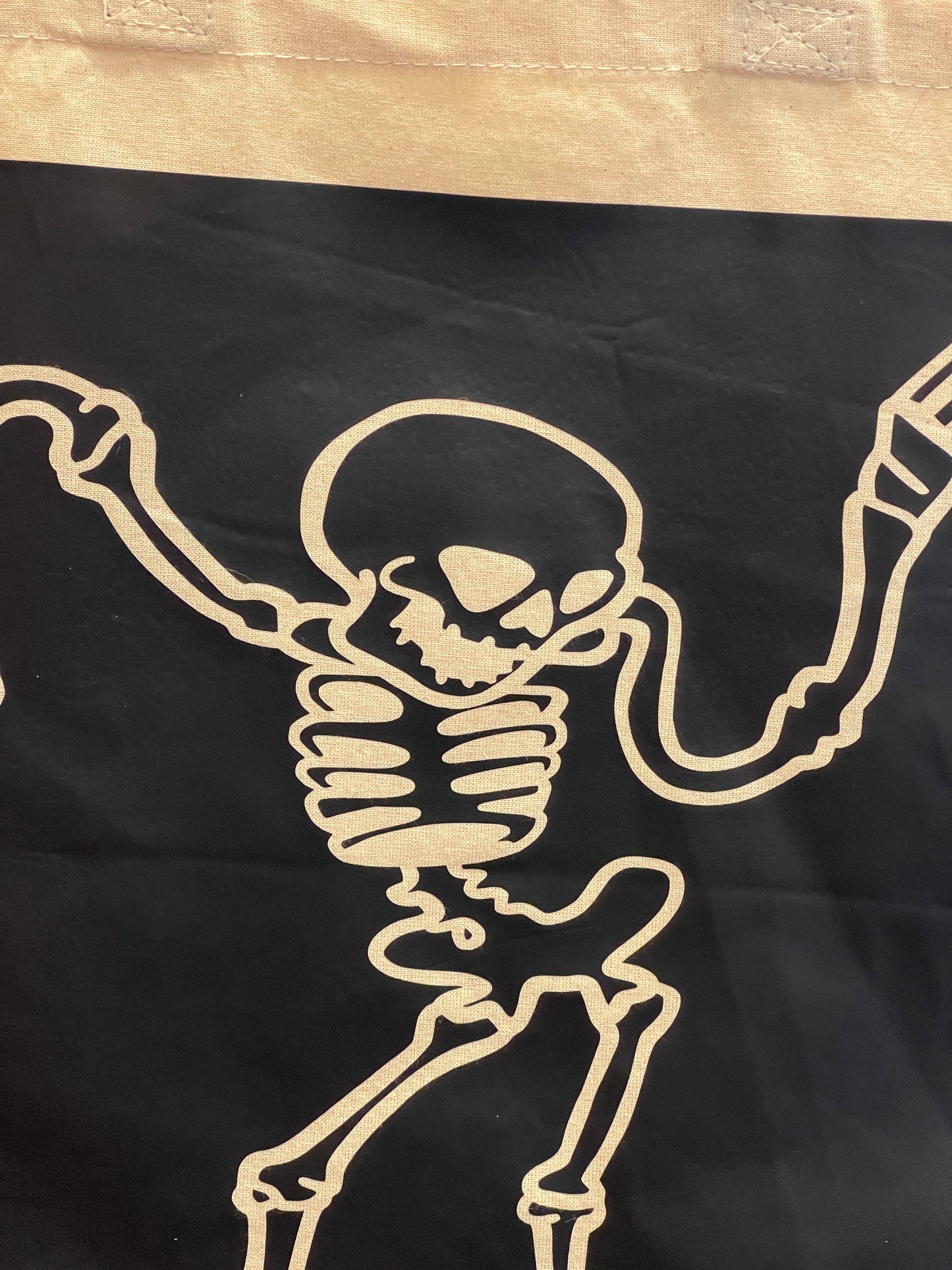 Canvas tote bag with a cartoon skeleton dancing design in black
