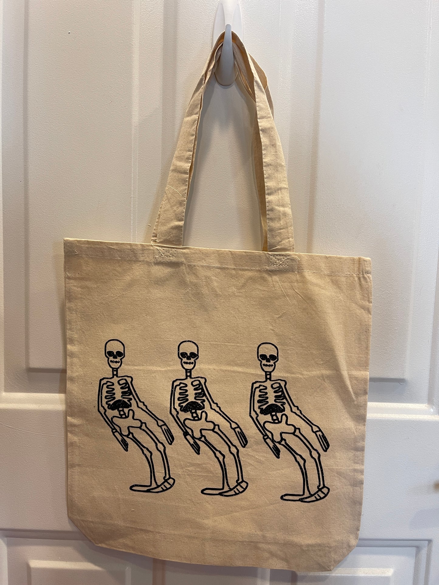 Canvas tote bag with a cartoon skeleton dancing design in black