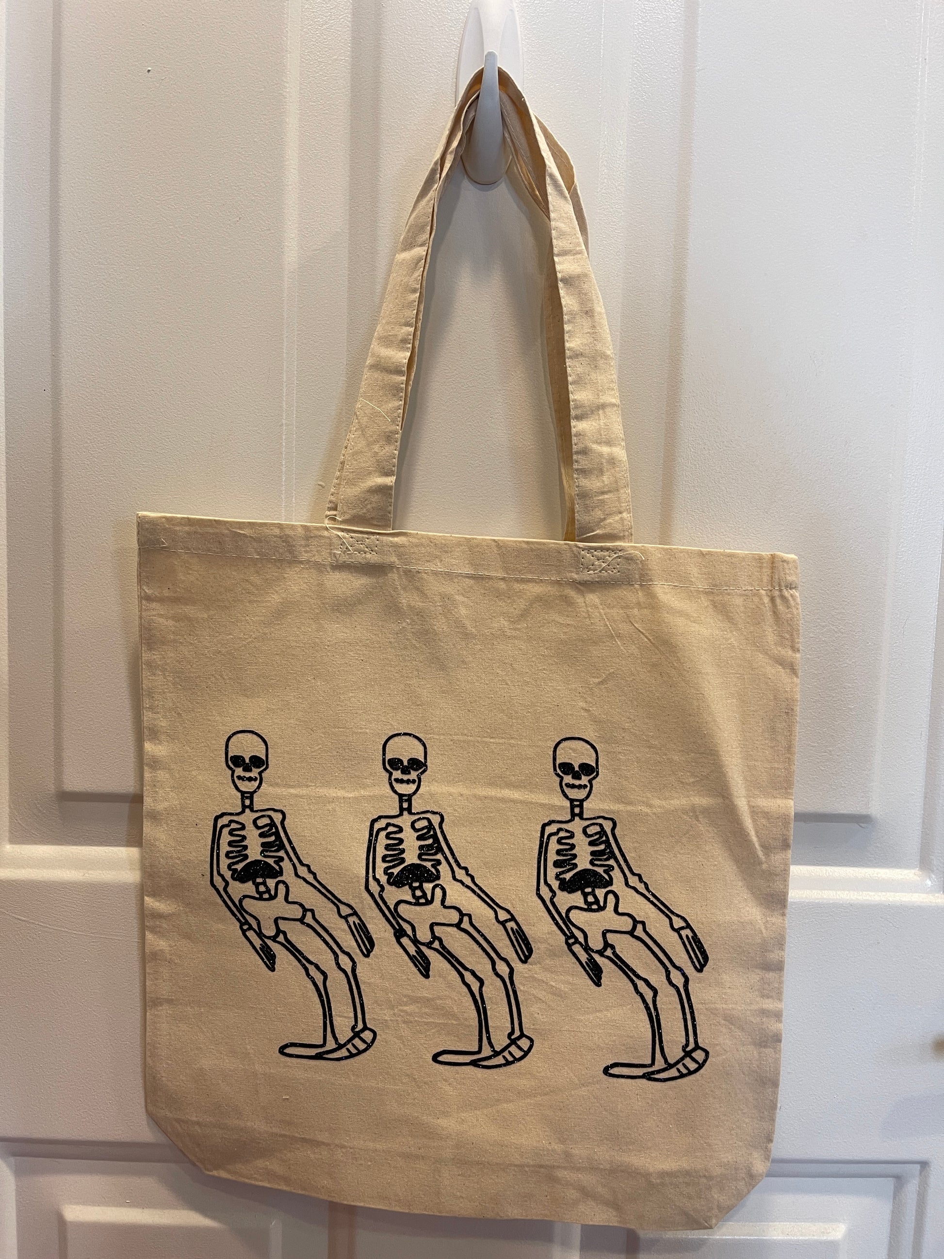 Canvas tote bag with a cartoon skeleton dancing design in black