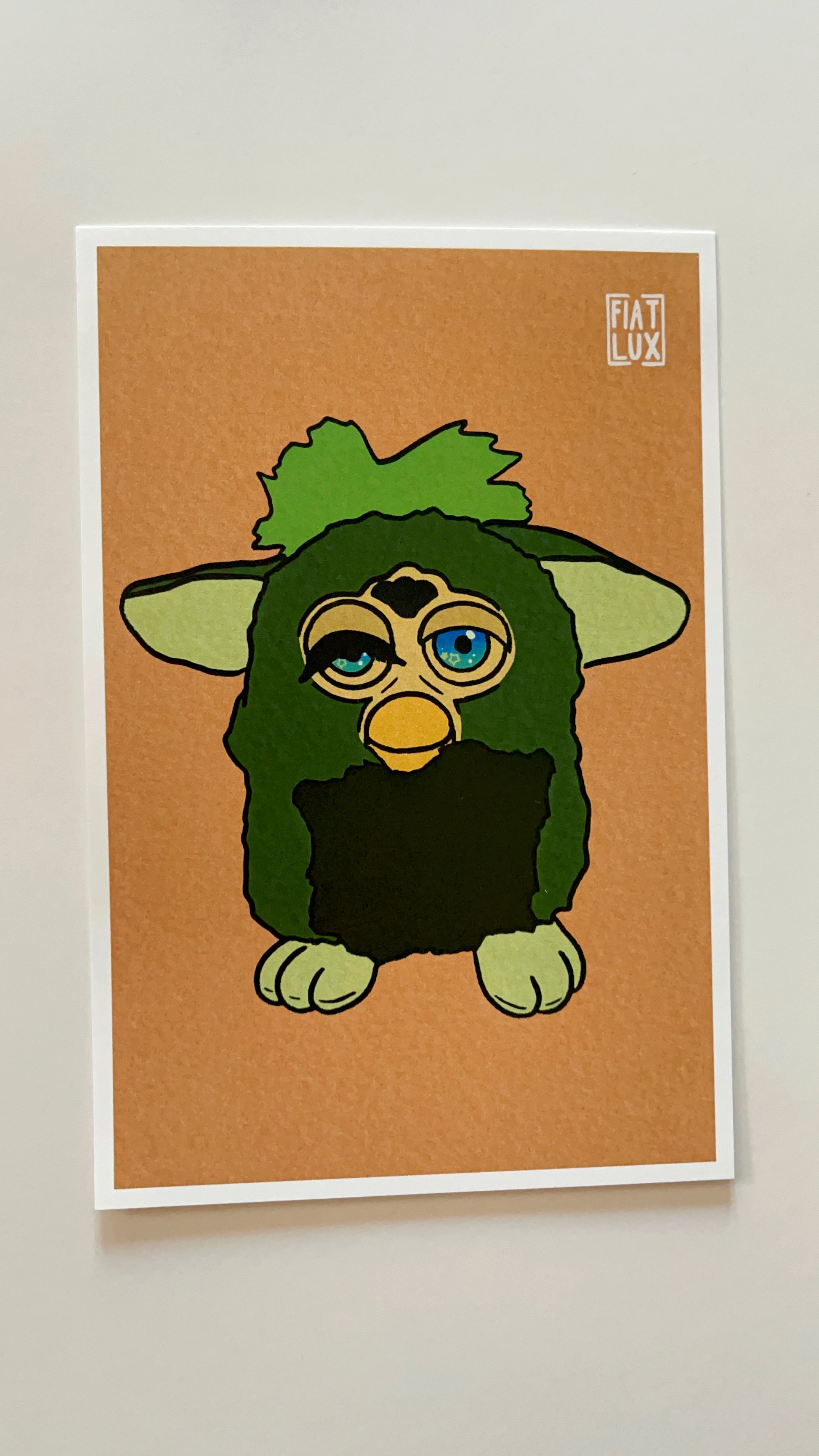 Art print of a furby with a missing eyelash and one eye drooping on a solid soft orange background.