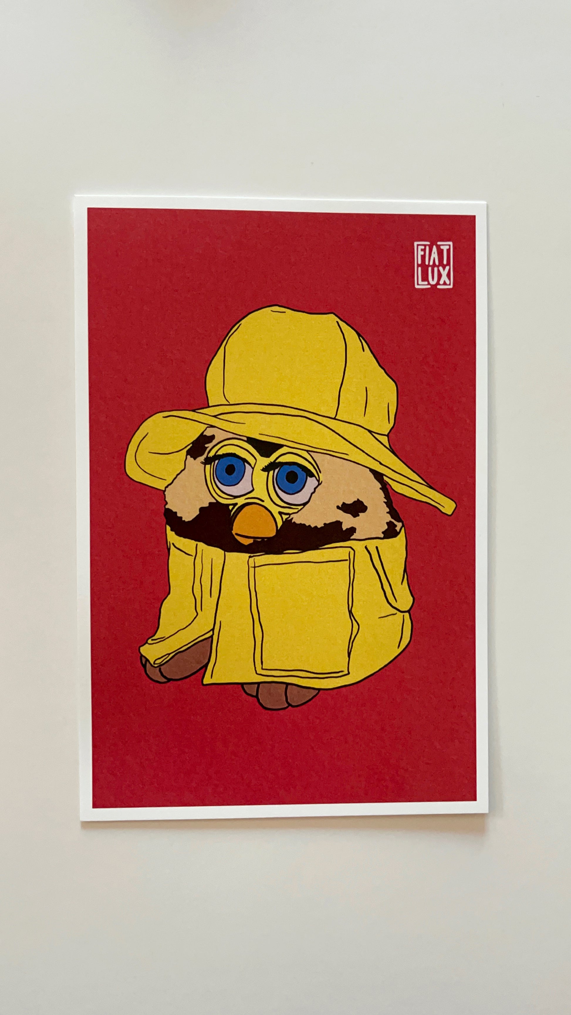 Art print of a furby in a yellow raincoat and matching bucket hat on a solid bright salmon background.