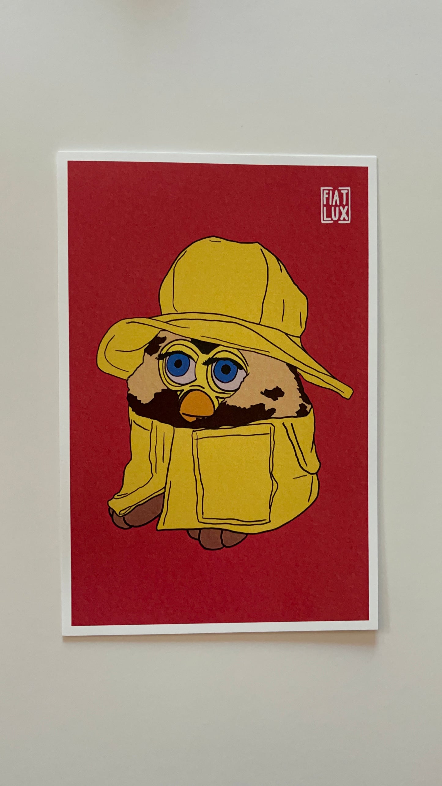 Art print of a furby in a yellow raincoat and matching bucket hat on a solid bright salmon background.
