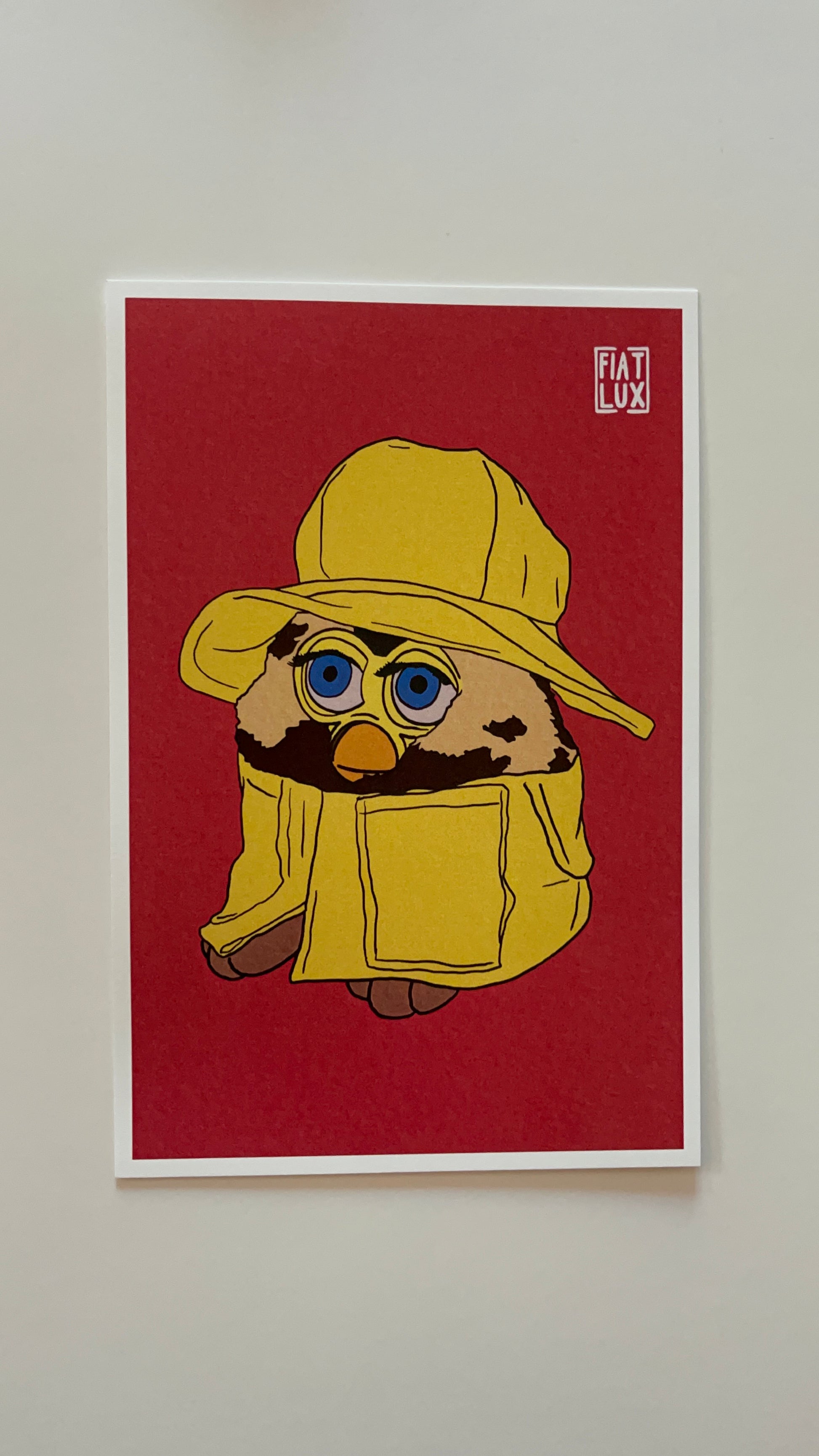 Art print of a furby in a yellow raincoat and matching bucket hat on a solid bright salmon background.