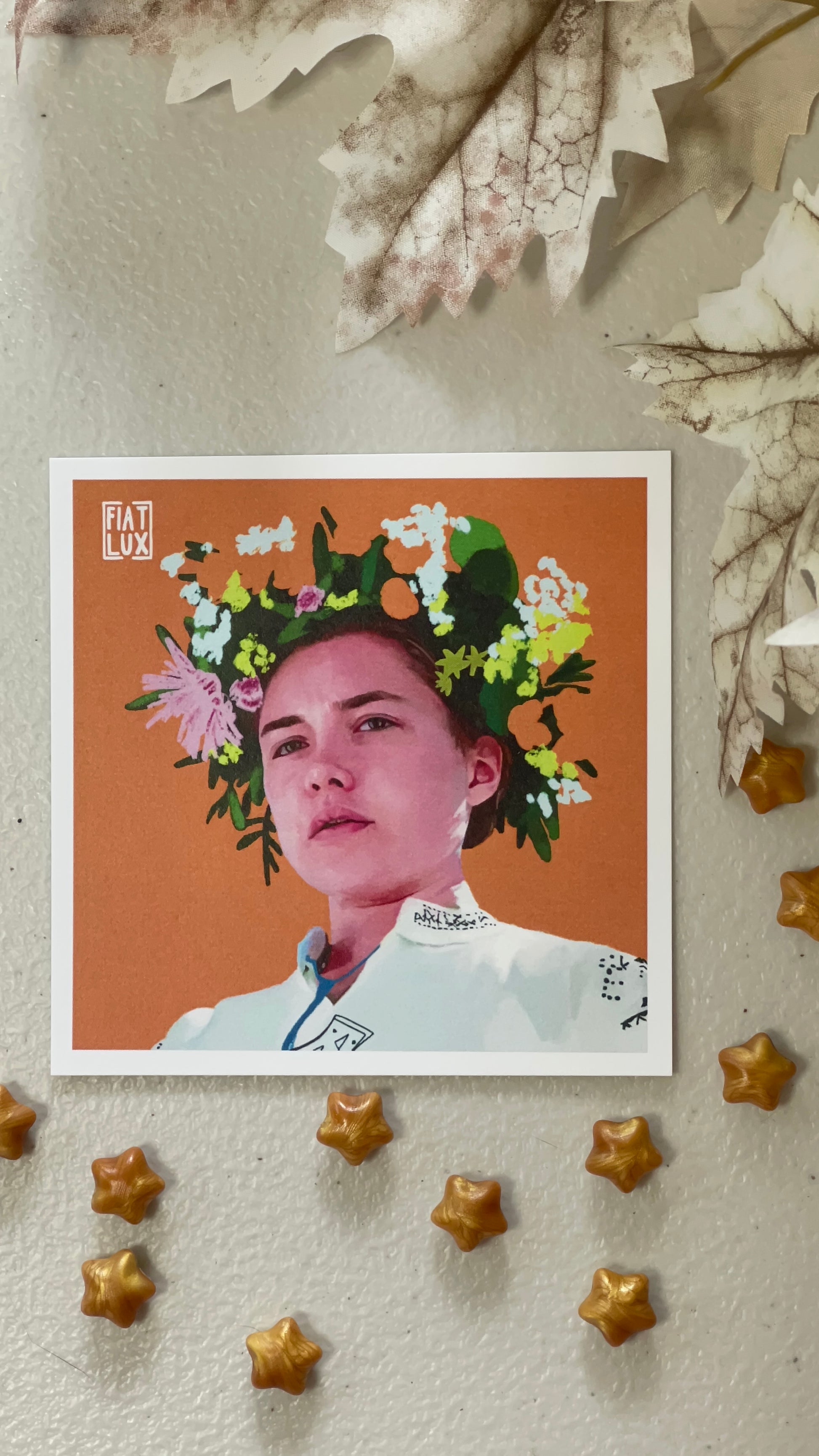 Art print of Dani from Midsommar with a flower crown on a solid orange background.