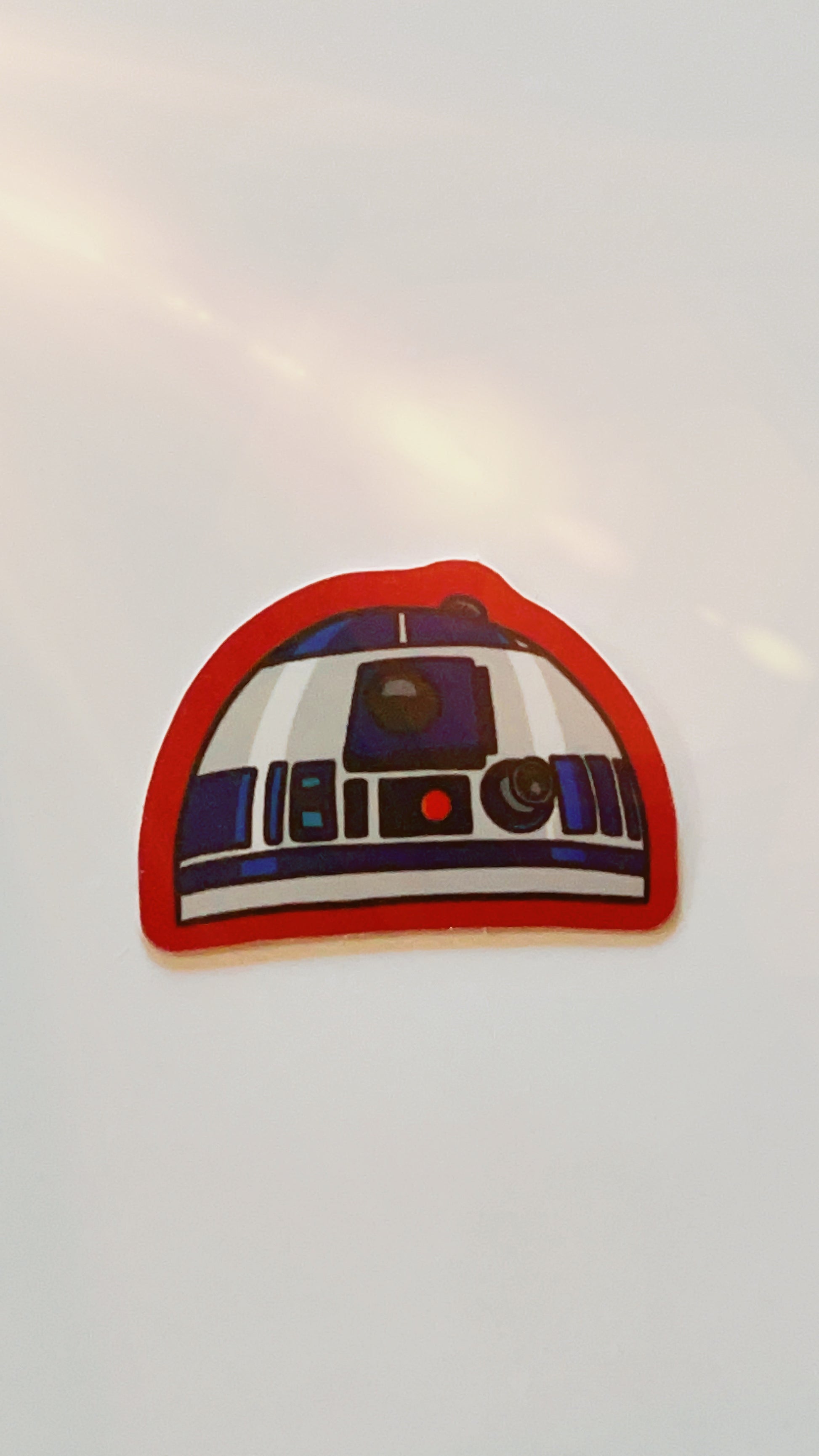 Vinyl sticker of star wars droid r2d2 with red edges.