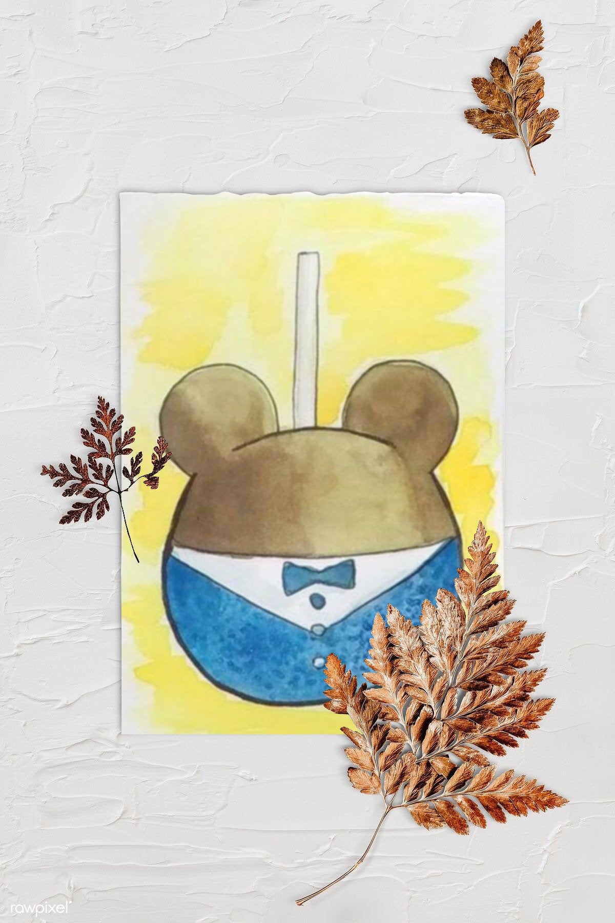 Theme Park Mickey 60th Anniversary Inspired Dessert Print - The Happiest Caramel Apples on Earth. Background is textured white with three browned fern leaves. Art print is lying in center with rough edges.