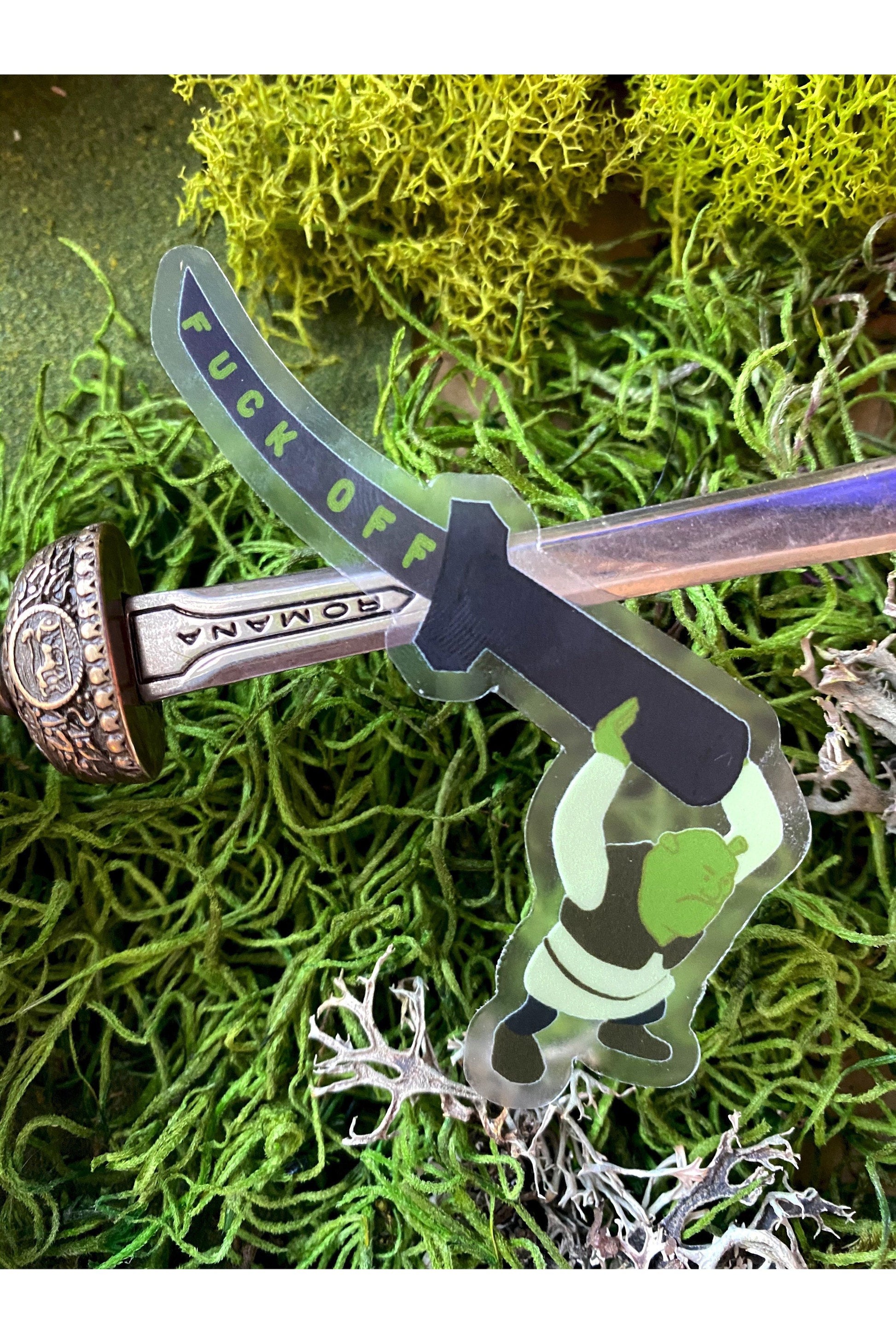 vinyl sticker of shrek holding a katana that reads fuck off in green text down the blade