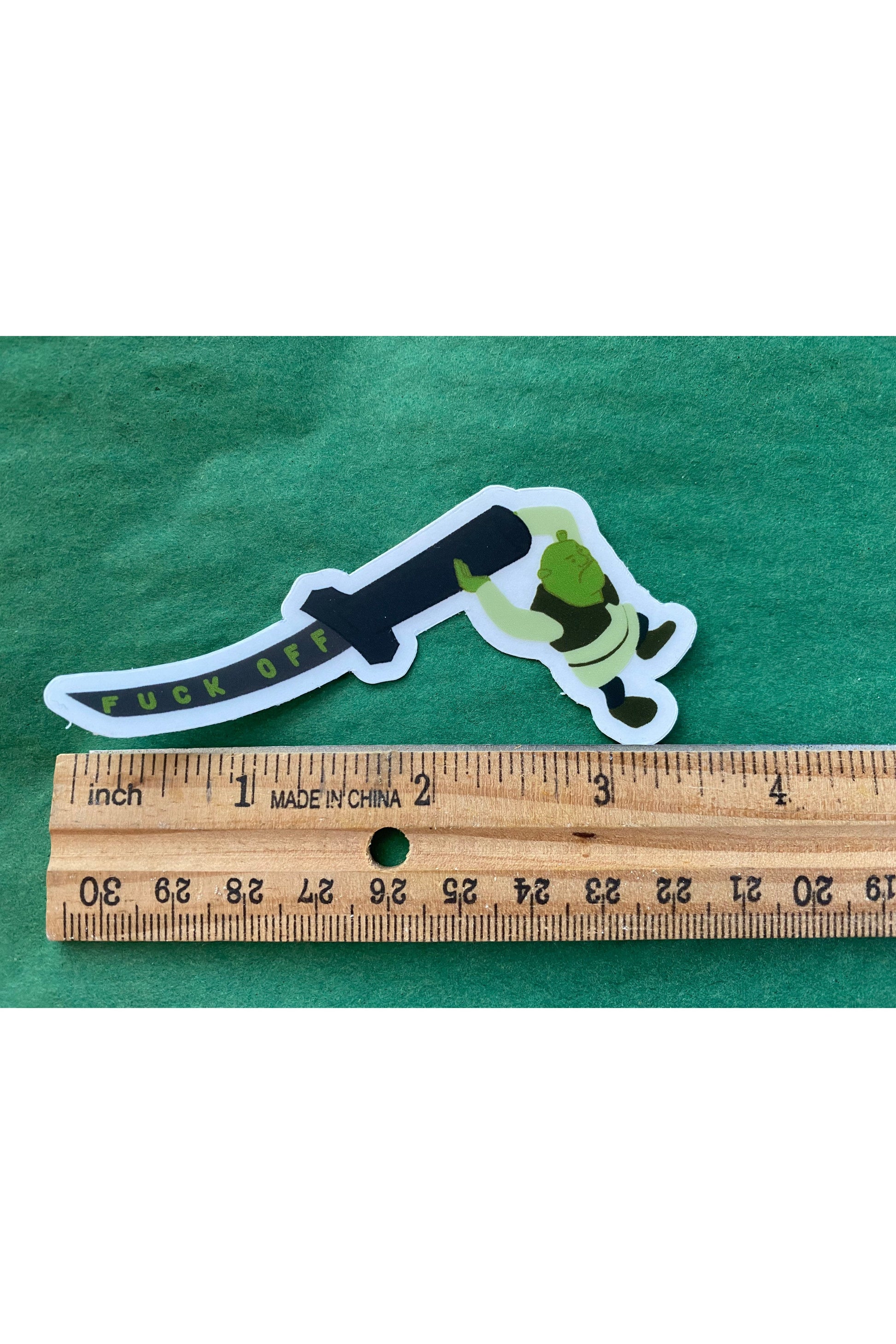 vinyl sticker of shrek holding a katana that reads fuck off in green text down the blade