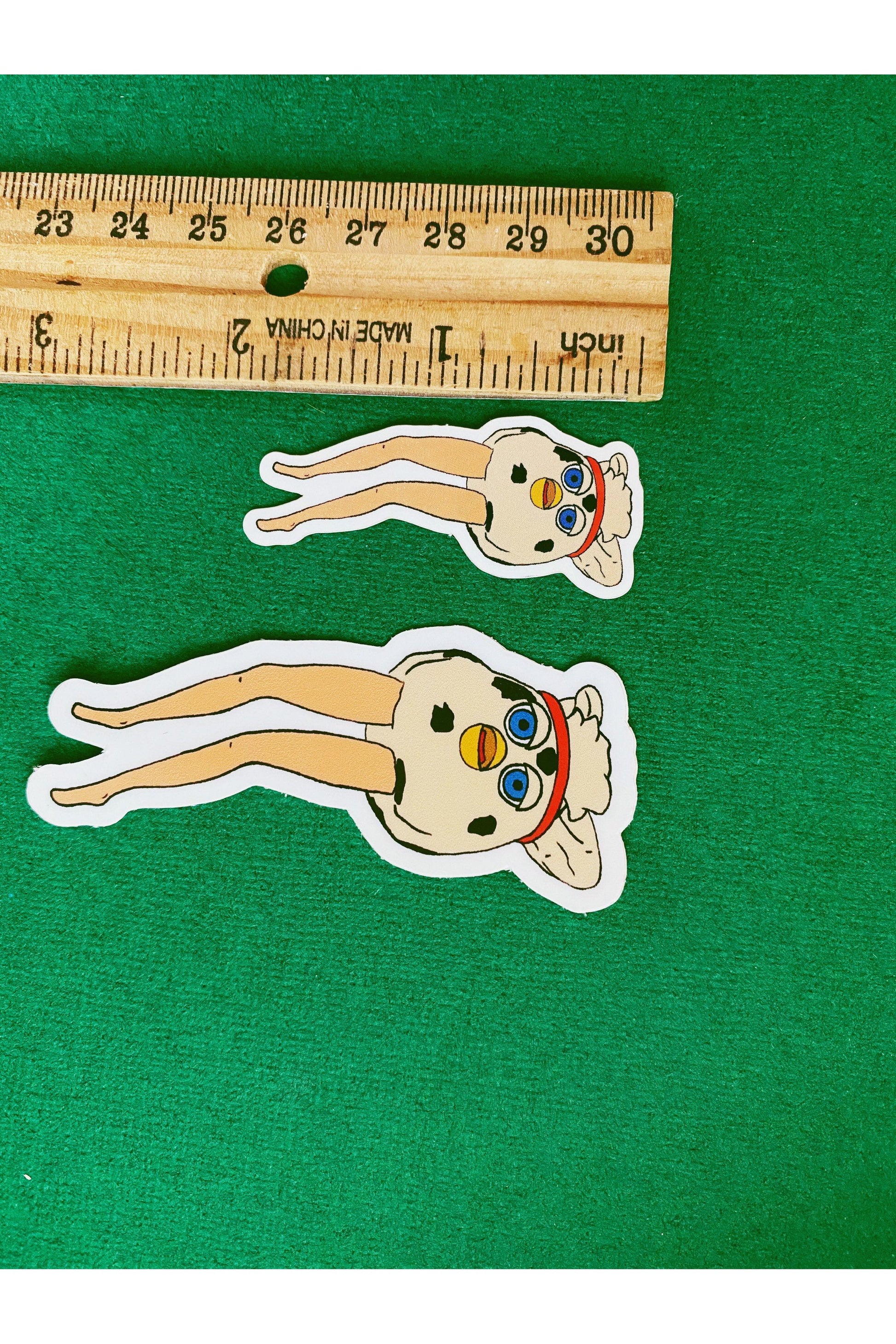 vinyl sticker of a furby modified with long doll legs
