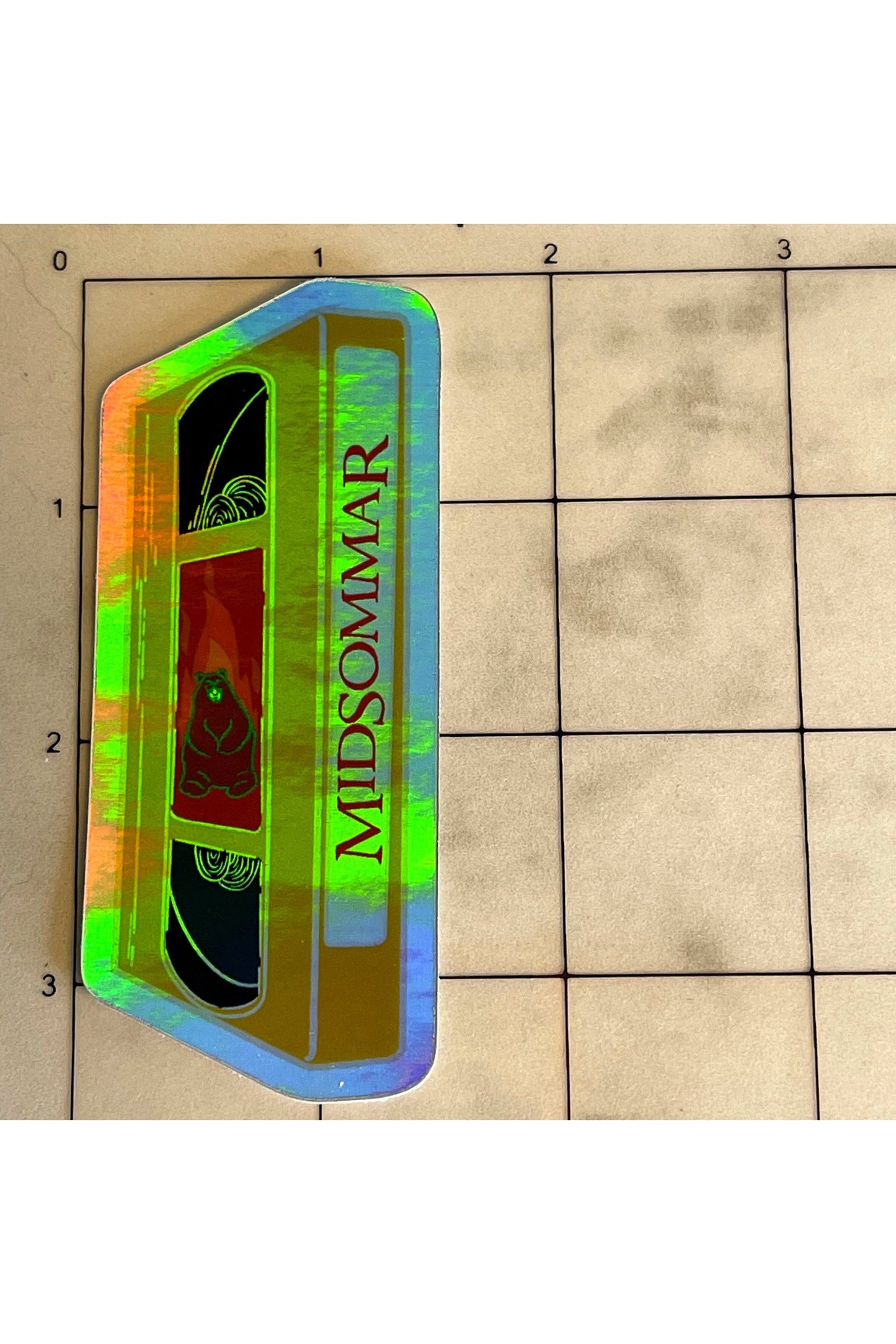 sticker of a yellow VHS tape of midsommar in holographic vinyl