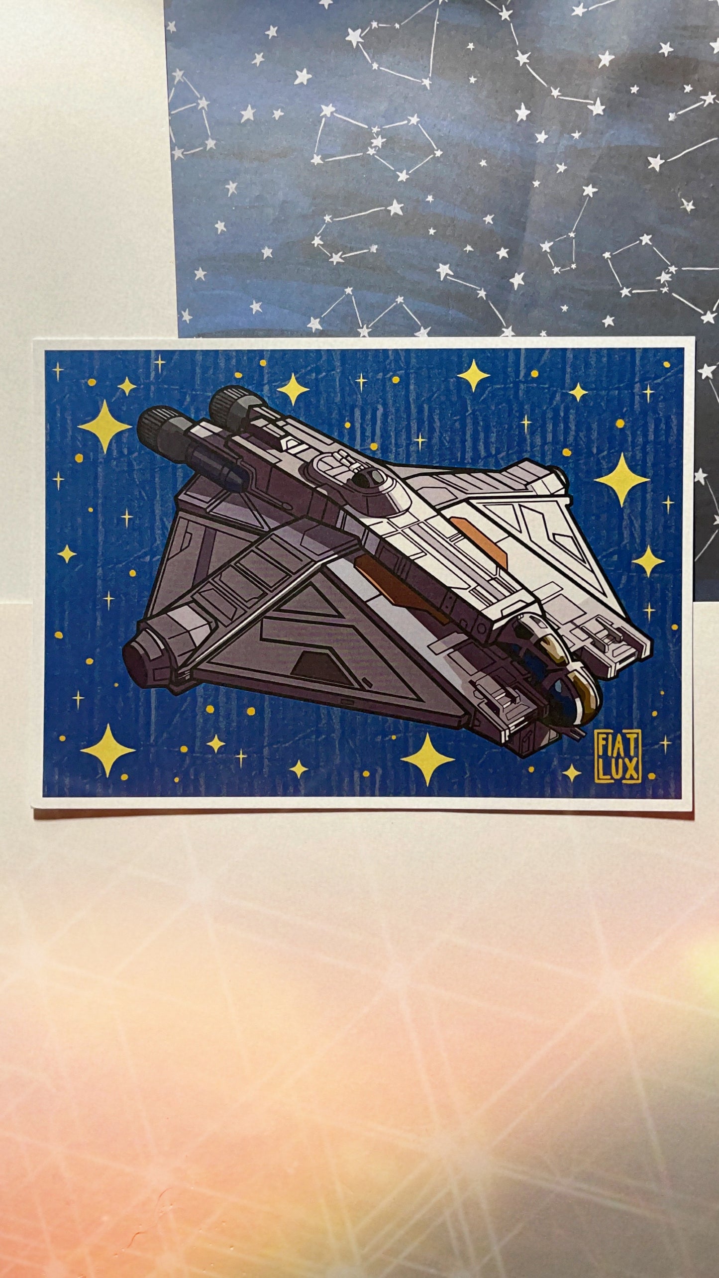 Art Print of hera syndulla's star fighter the ghost with a solid blue background with gold stars and a paper texture overlay